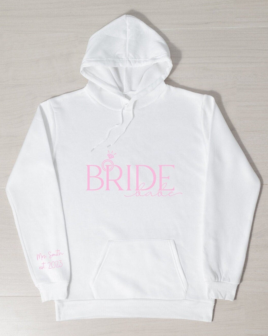 A white hoodie with the pink text 'BRIDE' on the front, displayed on a plain background.