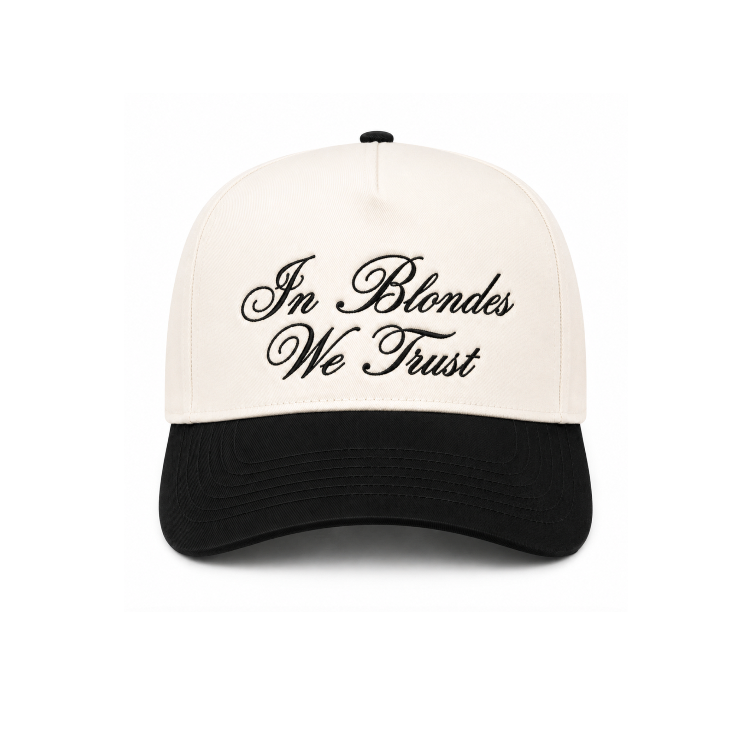 A structured baseball cap with an off-white crown and a black curved brim, featuring the phrase 'In Blondes We Trust' embroidered in black script across the front.