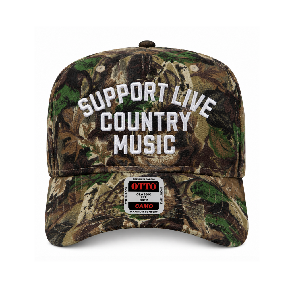 A classic six-panel baseball cap in a woodland camouflage pattern, featuring the text 'SUPPORT LIVE COUNTRY MUSIC' embroidered in white on the front. A sewn-on patch on the brim reads 'OTTO Classic Camo CAMO'.