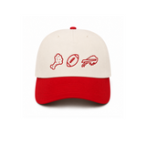 A two-tone baseball cap with an off-white crown and a red curved brim, featuring red embroidered icons of a chicken leg, a football, and a chicken wing on the front.